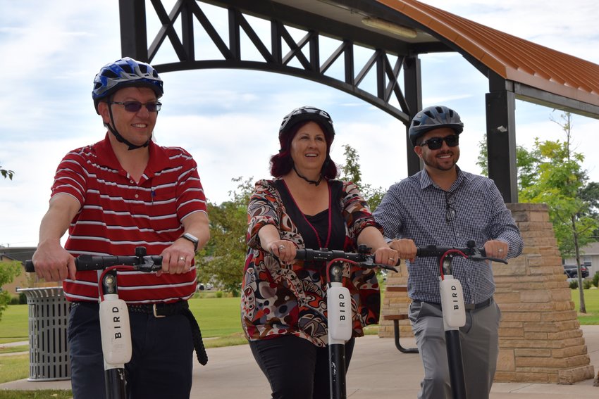 Mayor Greg Mills, Ann Taddeo, Brighton Councilwoman, and Michael Martinez, Brighton City Manager, on the new Bird Scooters, to celebrate deploying the ride to the city.